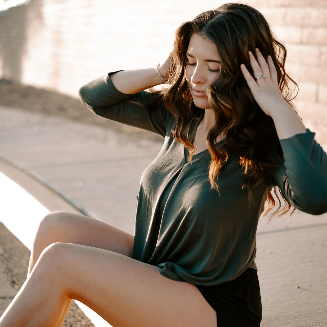 Model wearing Jia+Kate braless bamboo top, Eileen style with 3/4 sleeves in color olive with inverted pleat at center